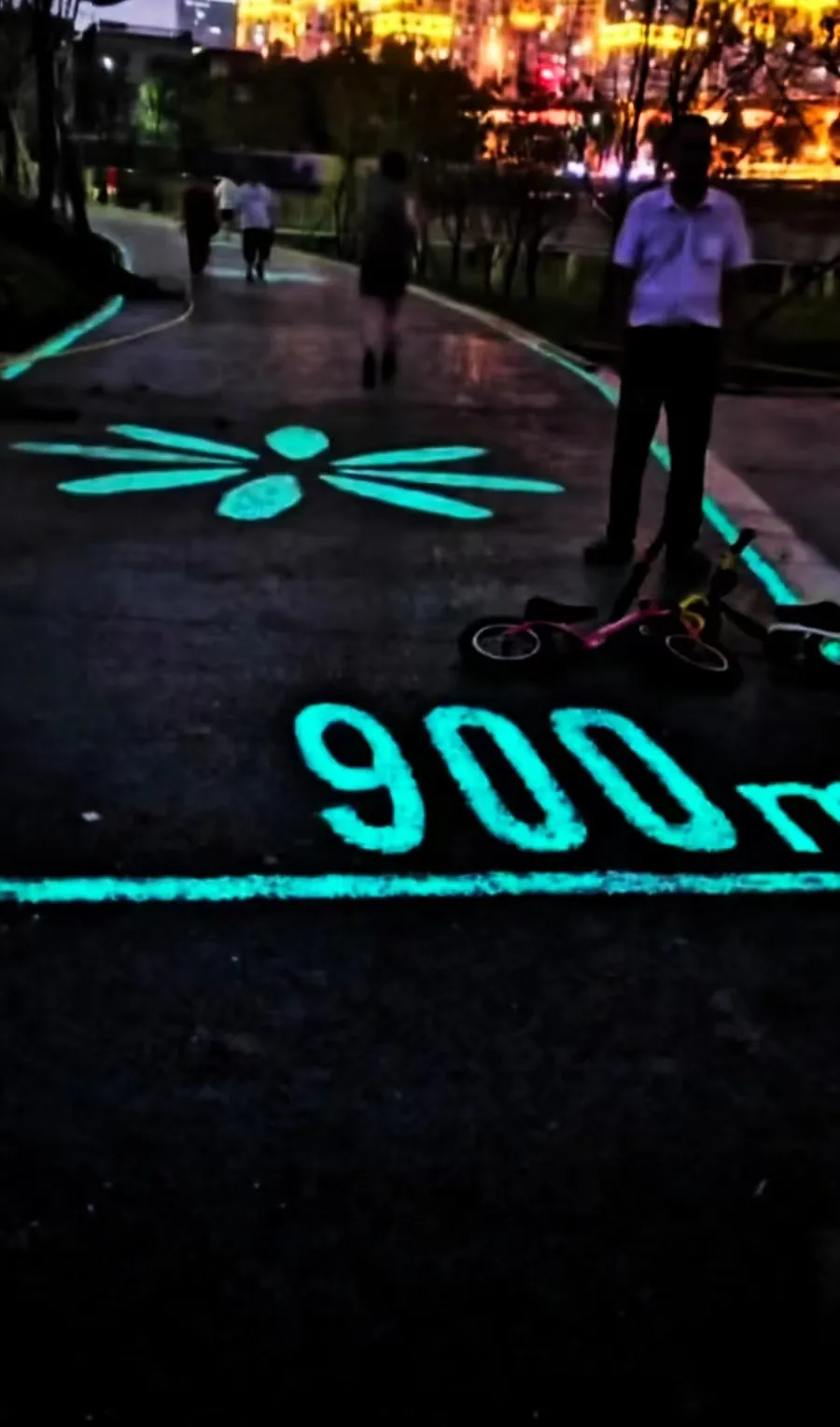 Blue-green photoluminescent pavement glowing after dark