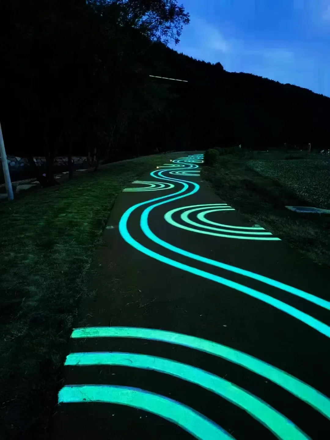 Blue-green luminescent coating on a path after dark